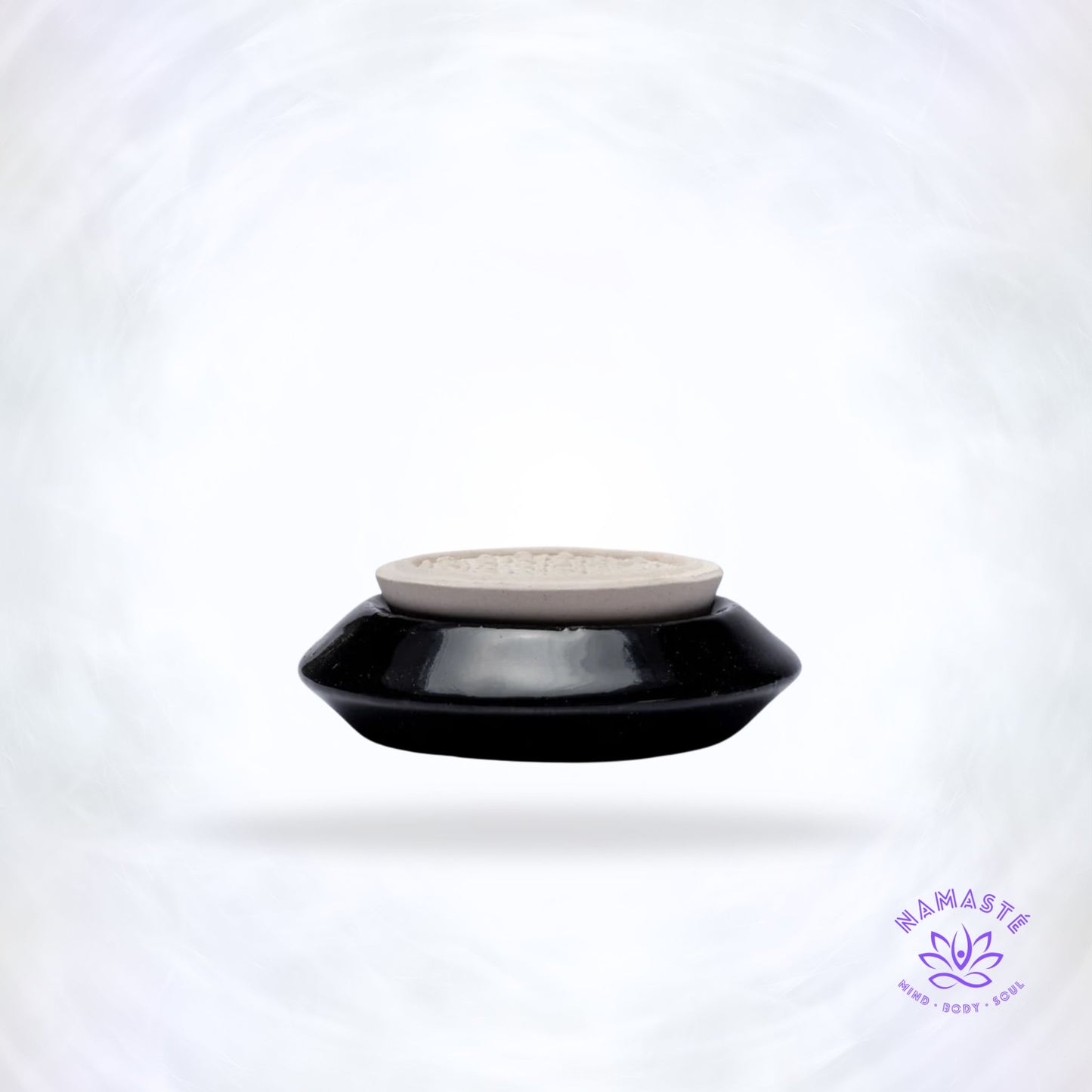 Zwarte keramische geursteen met Bloem des Levens symbool.