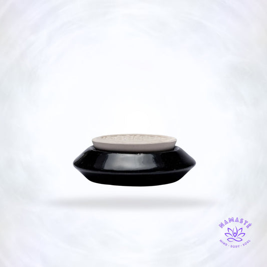 Zwarte keramische geursteen met Bloem des Levens symbool.