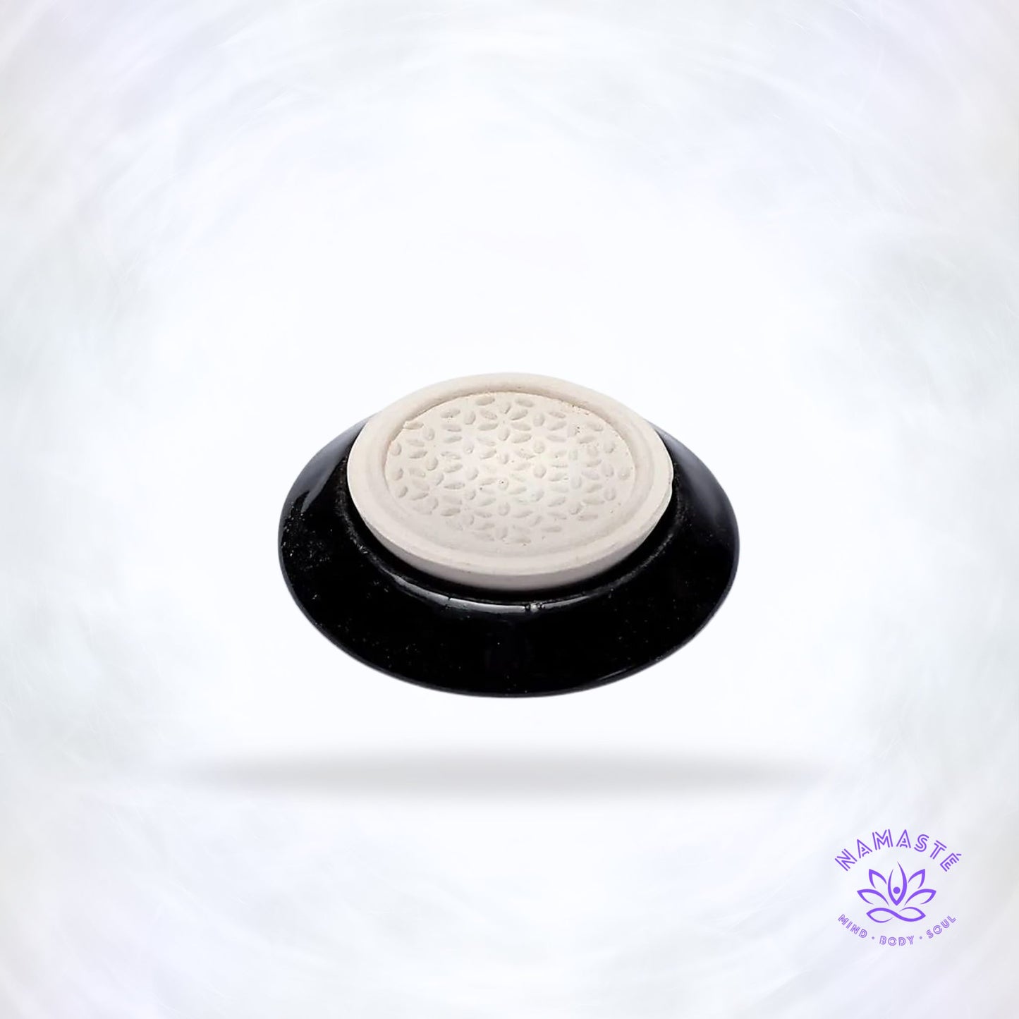 Zwarte keramische geursteen met Bloem des Levens symbool.